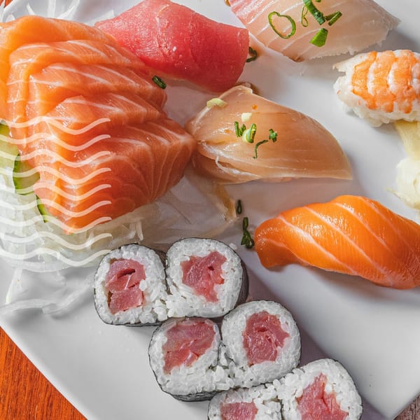 A platter of Akita Sushi Gourmet's fresh salmon and tuna sashimi, nigiri, and maki rolls.