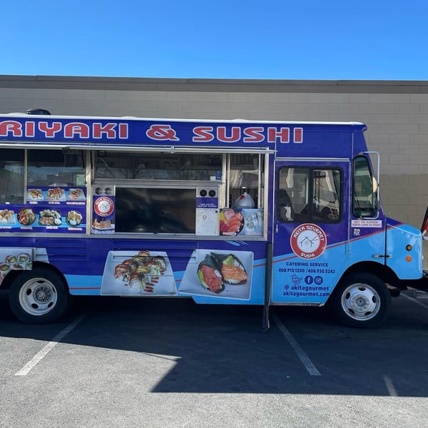 Akita Sushi Gourmet food truck, blue and purple, with sushi and teriyaki menu items displayed.